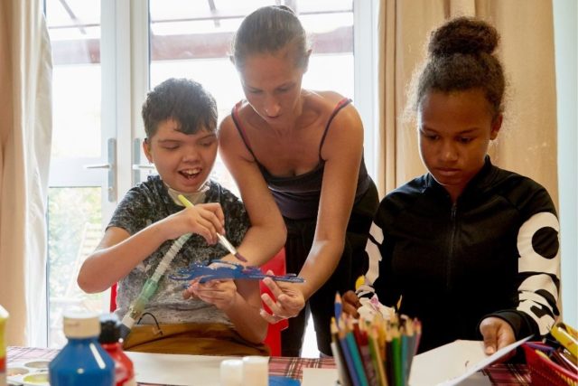 A family painting at Rainbows Hospice