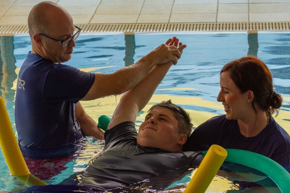 A young man having hydrotherapy at Rainbows