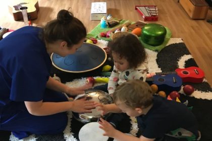 Two young children having music therapy at Rainbows