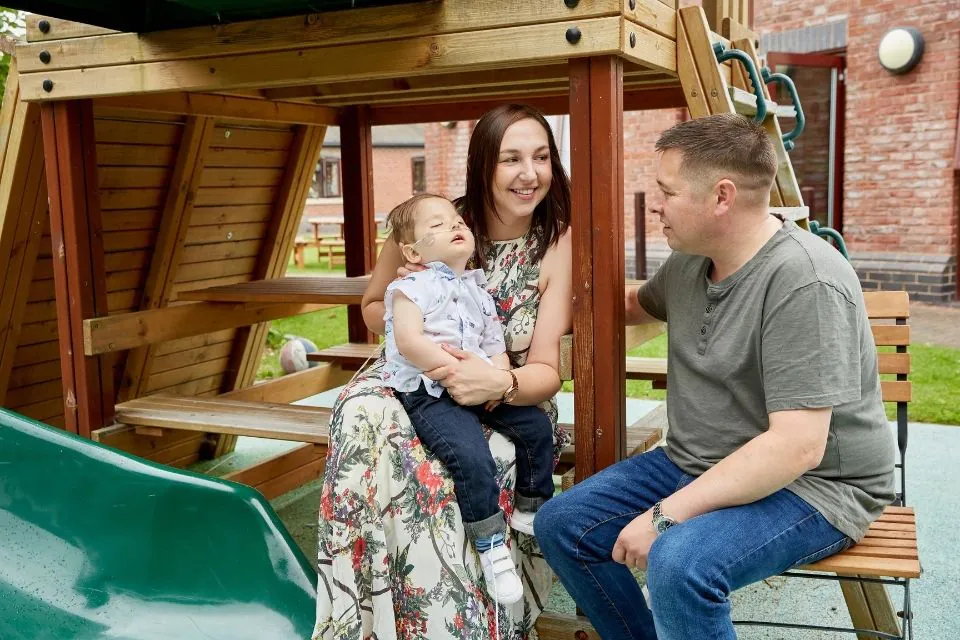 Parents with their son, all smiling