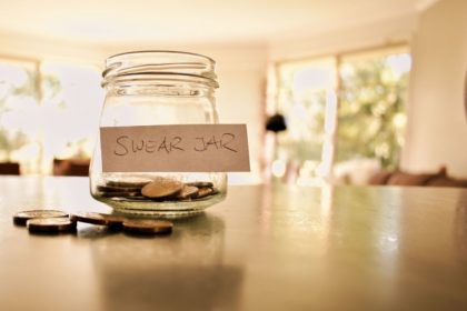 Swear jar with coins in it