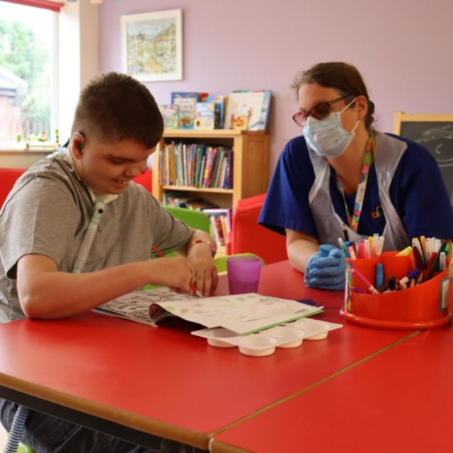 A young boy with a Care Team member