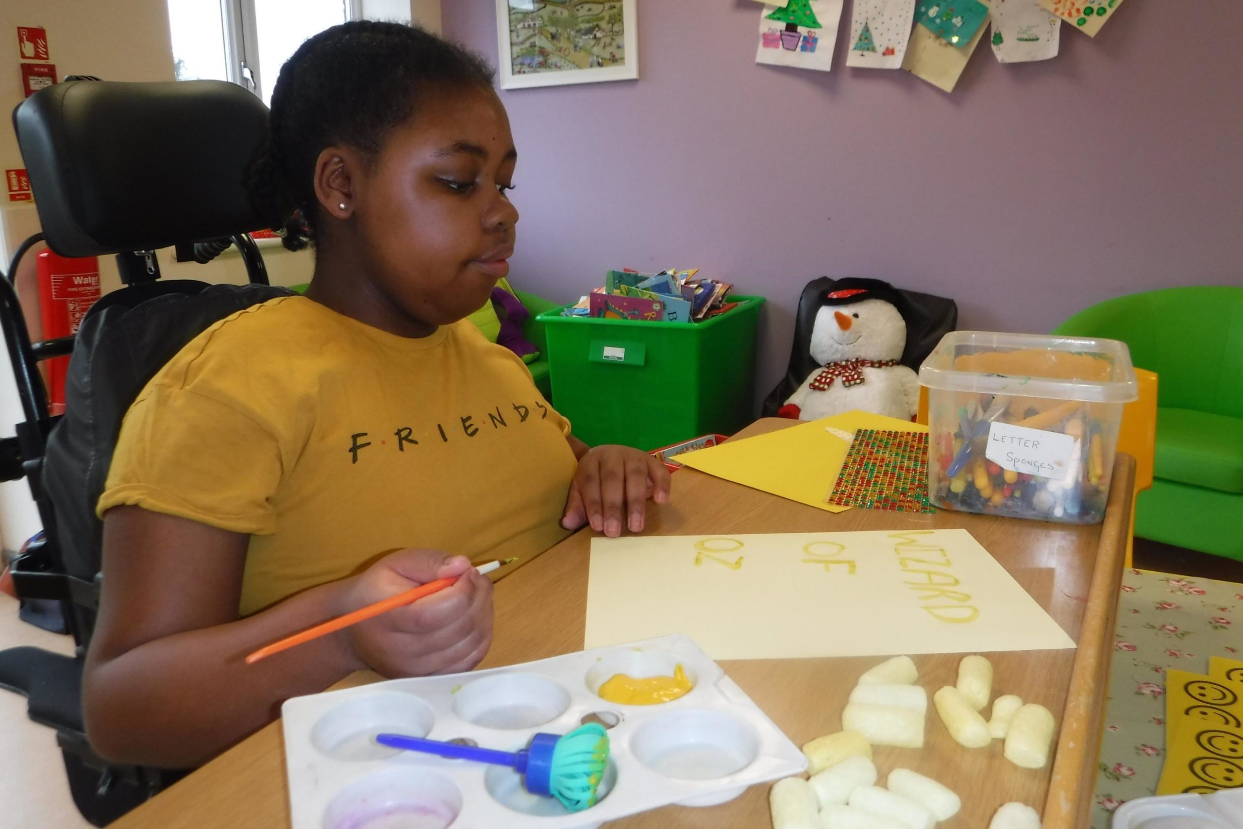 A young girl doing arts and crafts
