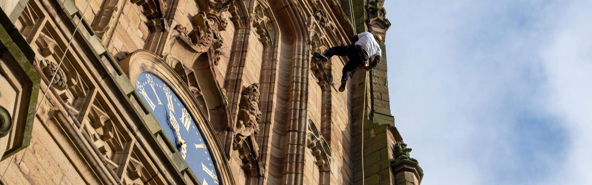 A person abseiling down Derby Cathedral