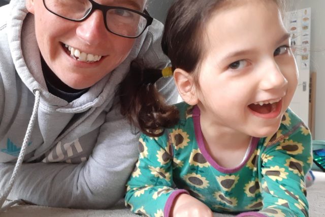 A mum and daughter smiling