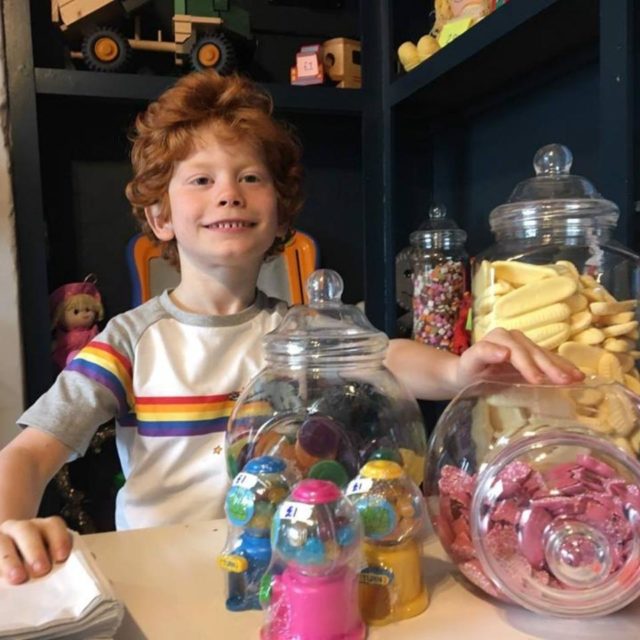 A smiling child with sweets