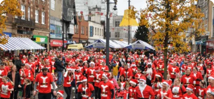 Crowd of people dressed as Santa in Loughborough Market Place